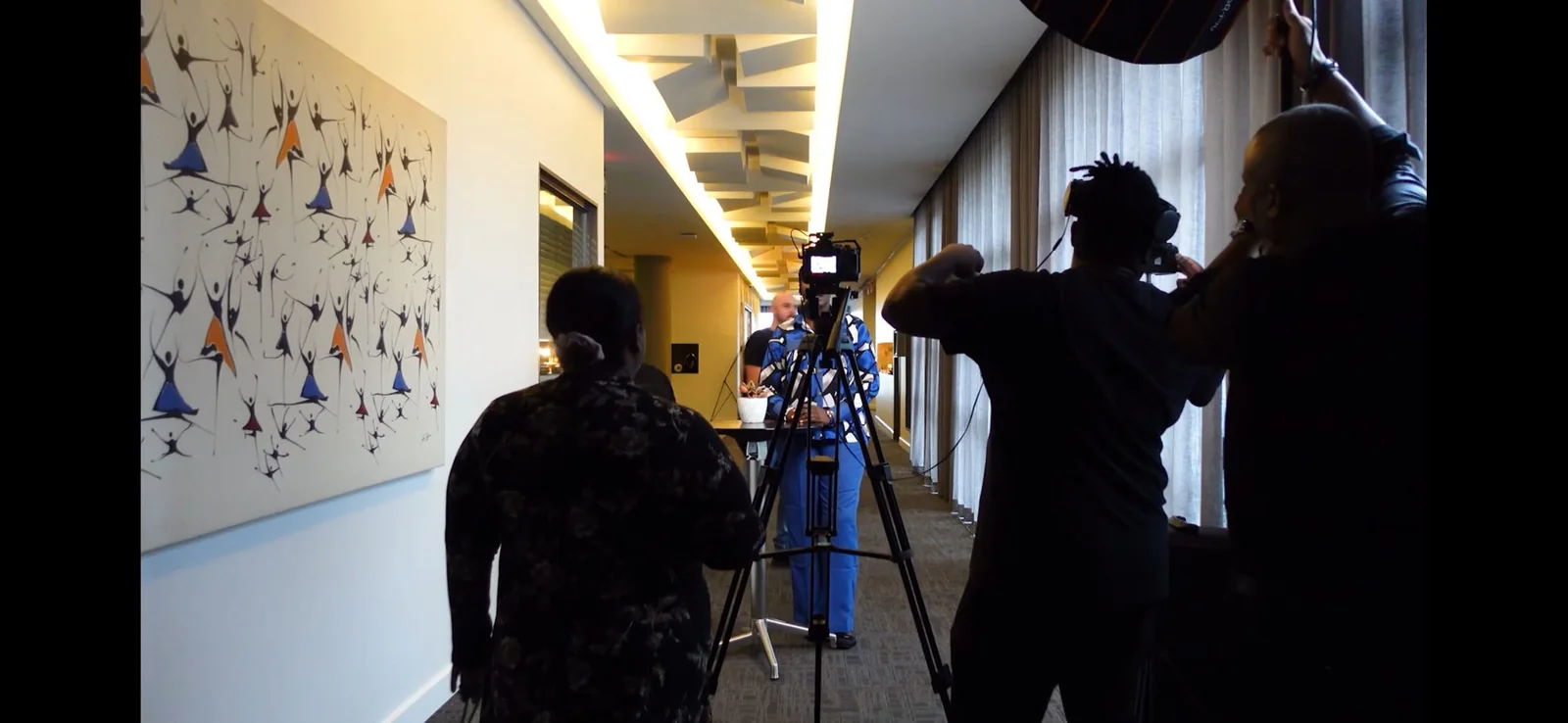 Camera crew setting up an indoor interview