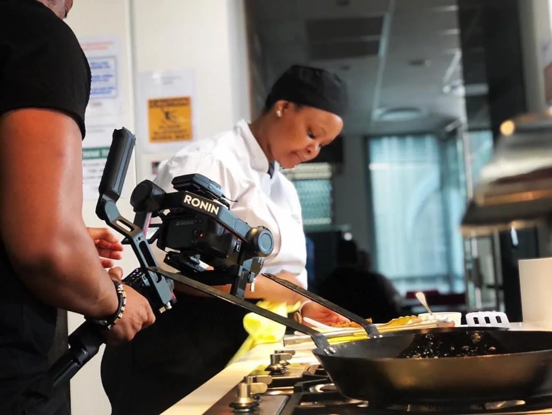 Camera crew filming a chef preparing food