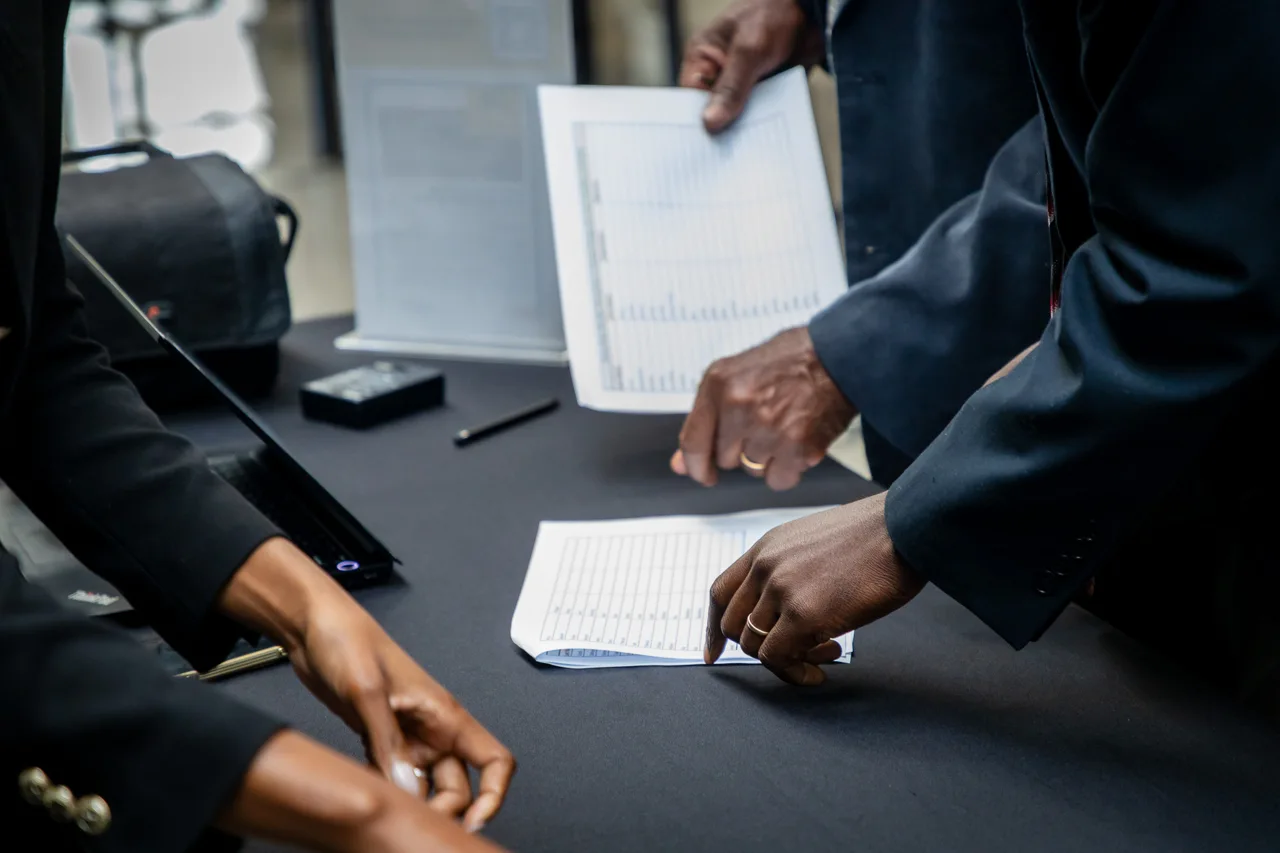 Participants reviewing documents together at an event
