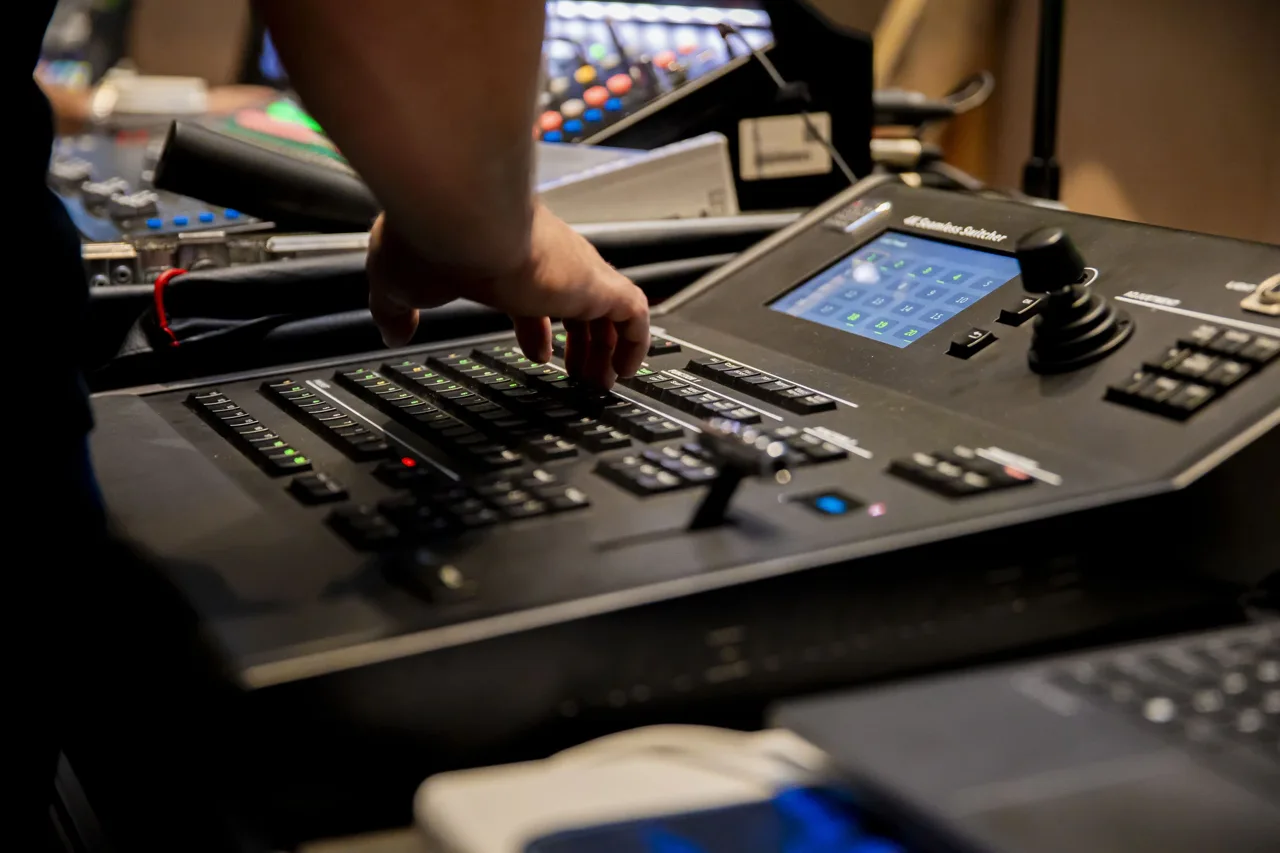 Operator adjusting an audiovisual mixing desk