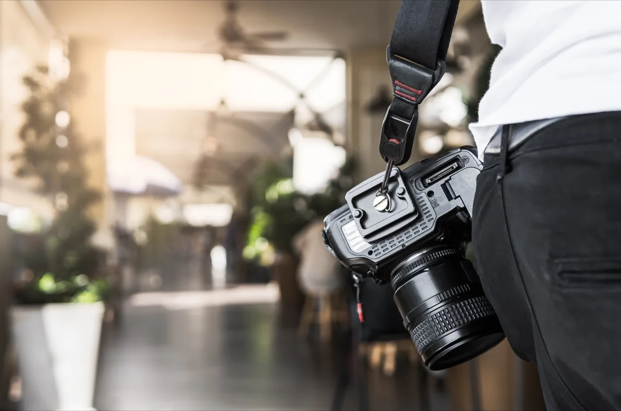 Photographer carrying a professional camera